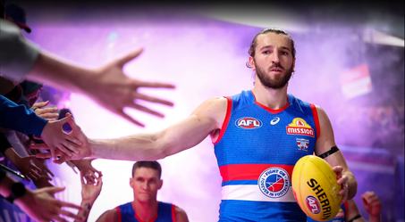 A Western Bulldogs player high-fives supporters in the race
